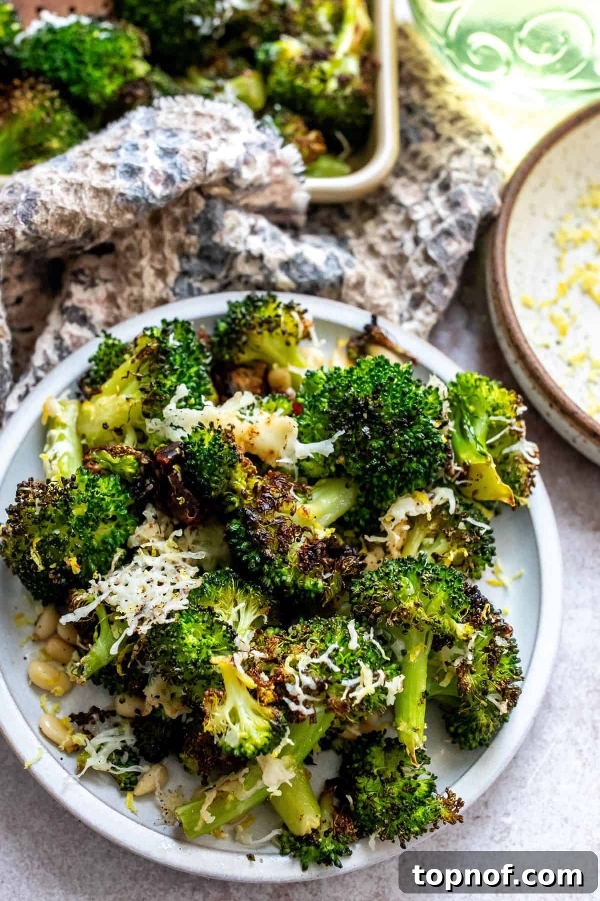 A beautifully plated dish of Charred Broccoli with lemon slices and scattered dates.