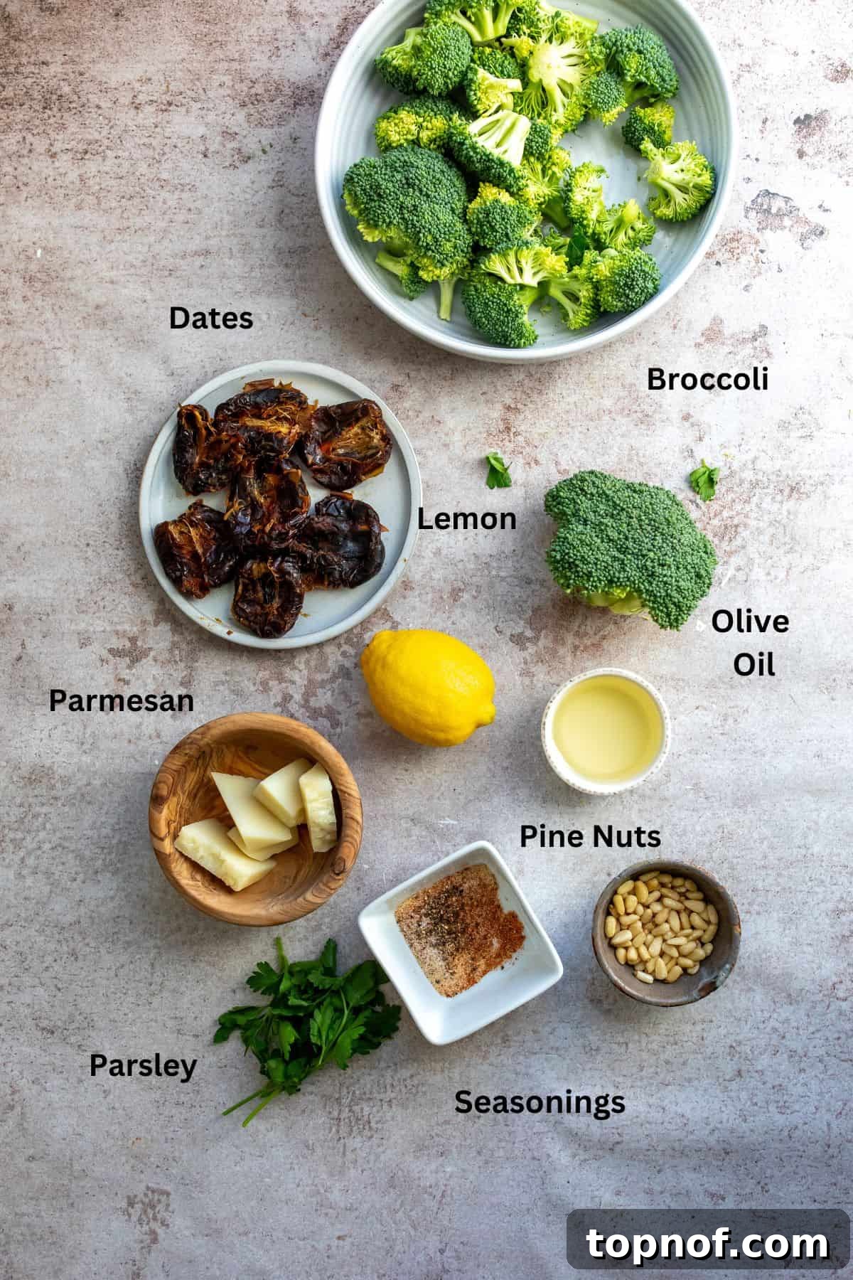 A selection of fresh ingredients including broccoli, dates, lemons, and seasonings in small bowls, ready for cooking.