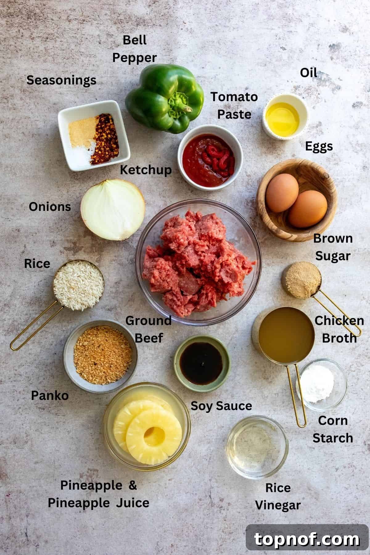 Zesty Meatball Bites 3 A collection of fresh vegetables and sweet and sour sauce ingredients, including bell peppers, onions, pineapple, and various condiments, neatly arranged on a kitchen counter.