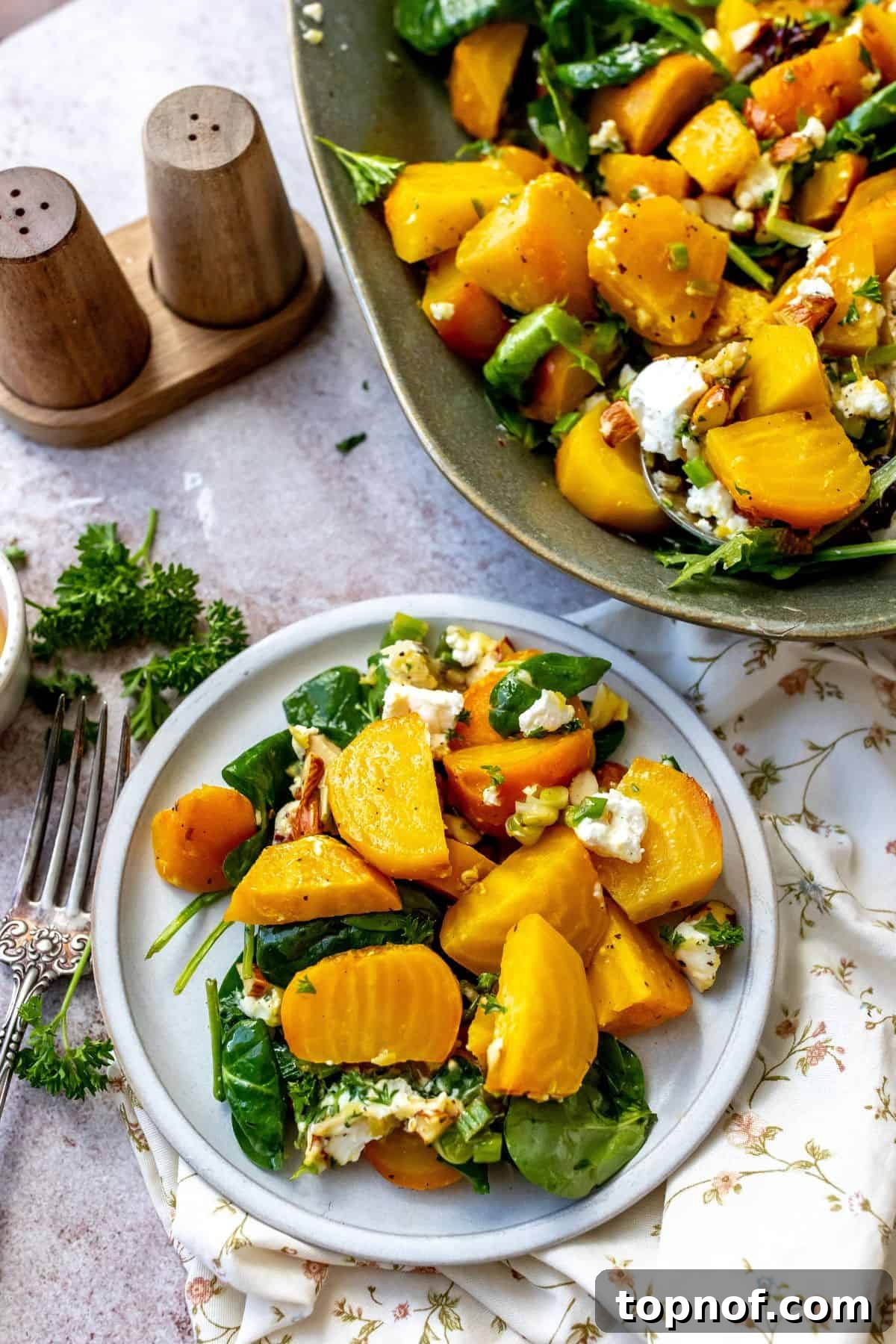 Golden Roasted Beets Perfection 6 Roasted Golden Beets on a green serving plate with toppings and a small white salad plate on the side.