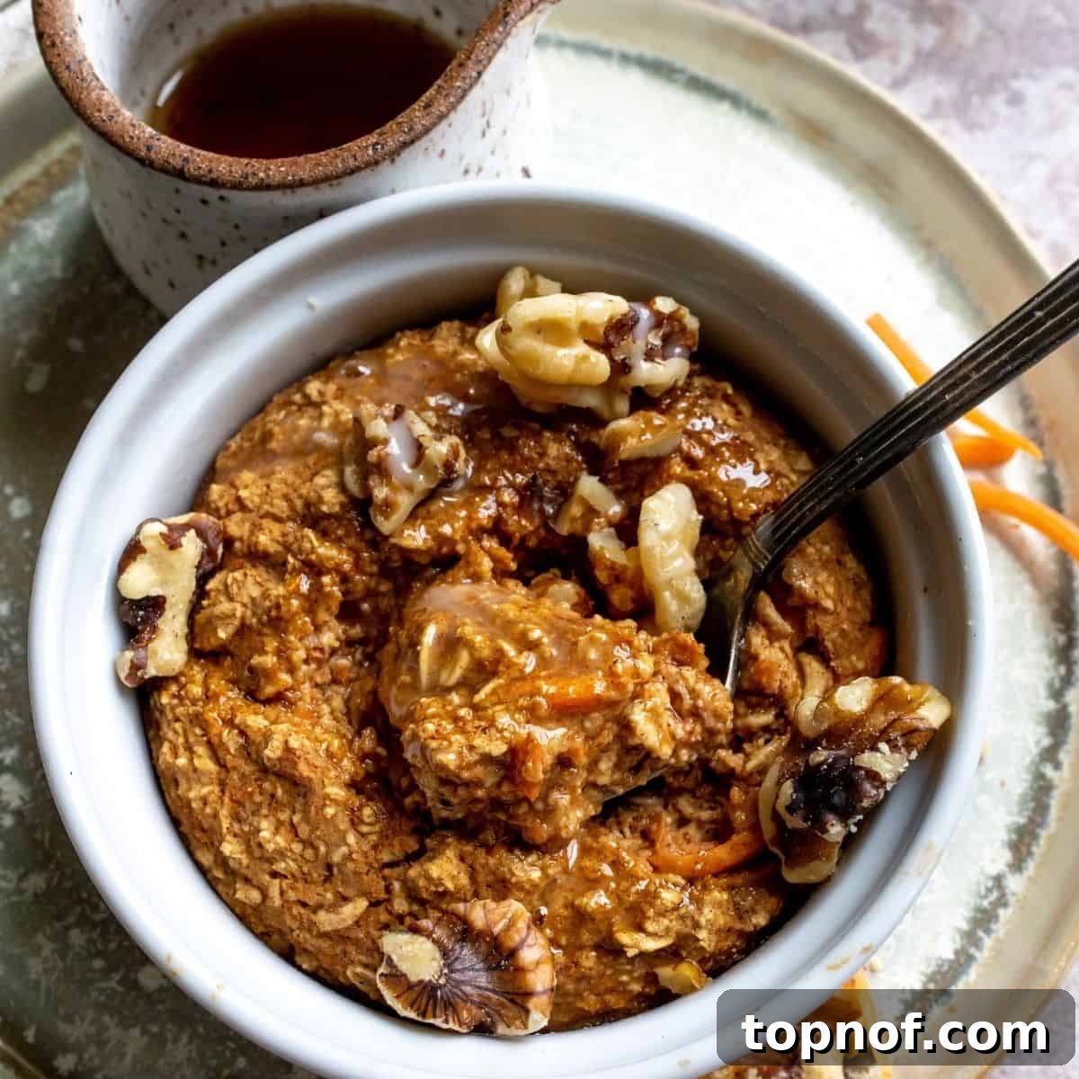 A warm and comforting bowl of Vegan Baked Carrot Cake Oats, ideal for a sweet breakfast or dessert.