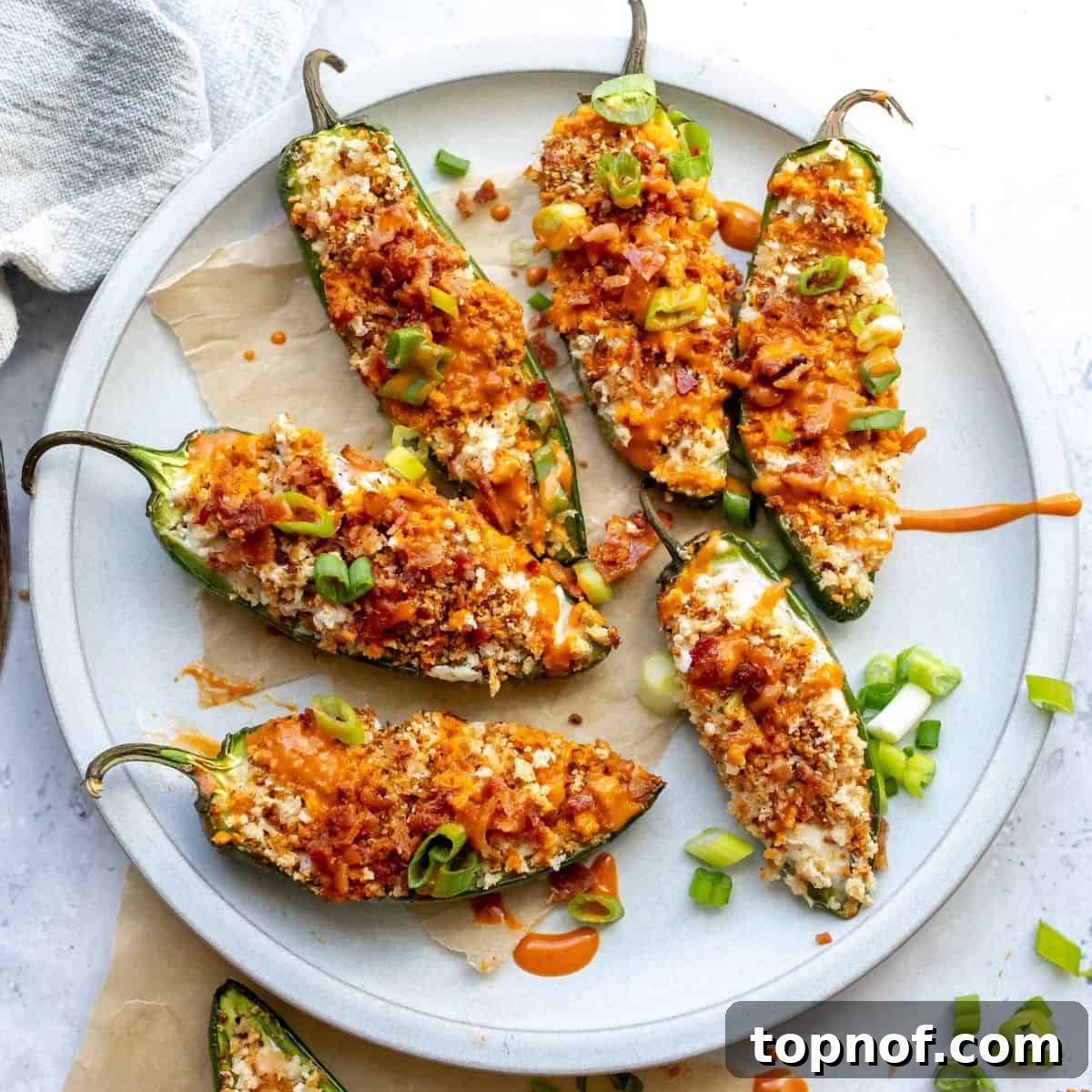 Oven Baked Jalapeño Poppers on a plate up close, an overhead shot showcasing their crispy goodness.
