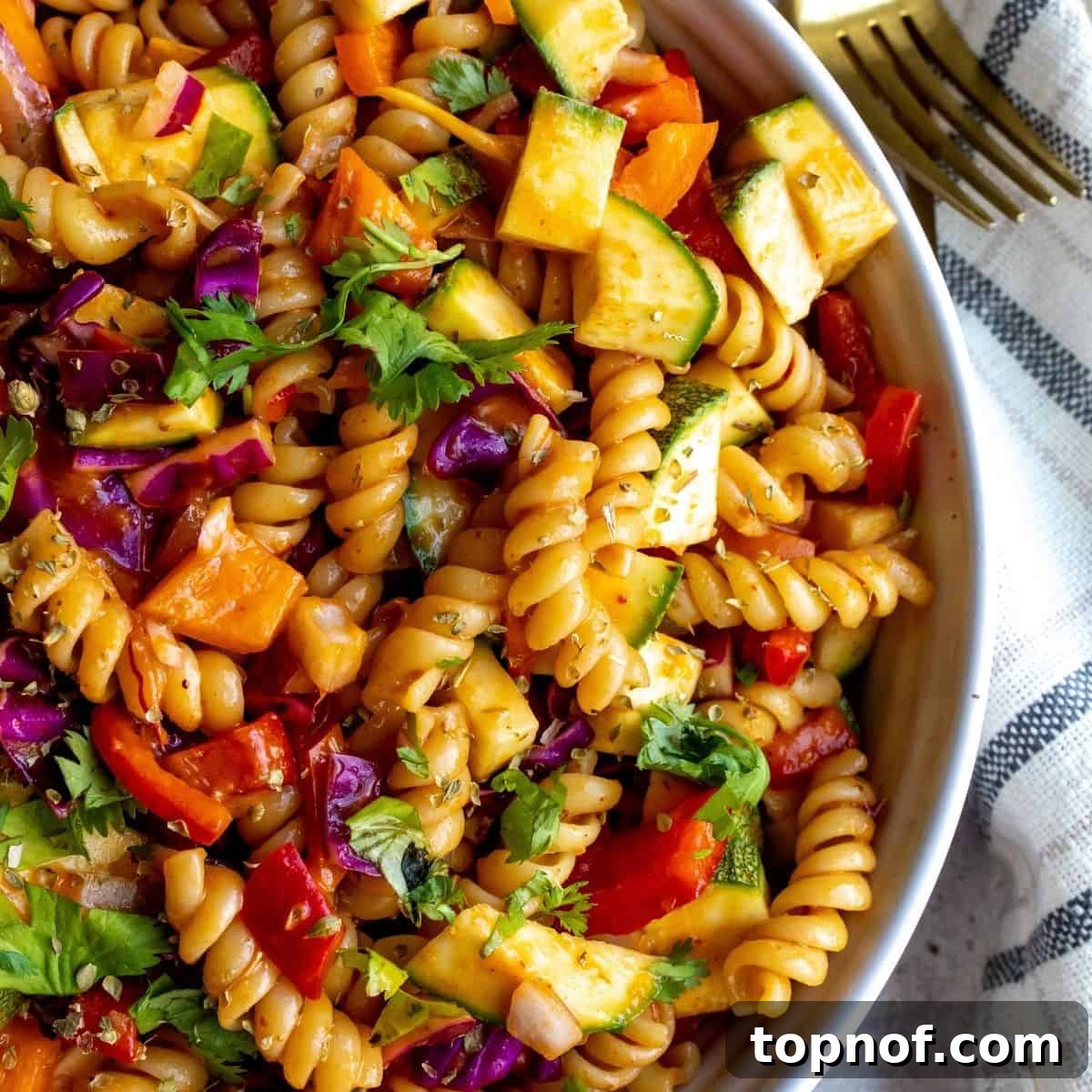 Southwest Chipotle Pasta Salad in a white bowl, looking incredibly flavorful.