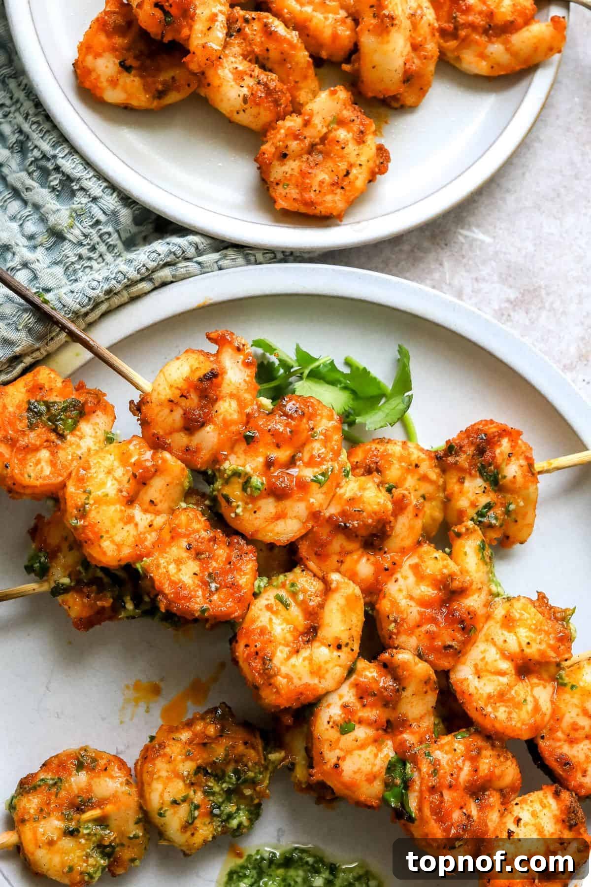 Oven-Kissed Shrimp Skewers 6 A close-up shot of several perfectly cooked oven-baked shrimp skewers, glistening with marinade and ready to serve.
