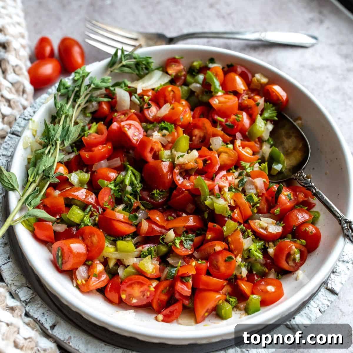 Hearty Tomato Relish in a large serving bowl with a silver serving spoon.