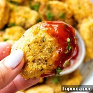Crispy homemade chicken nugget with a drop of ketchup.