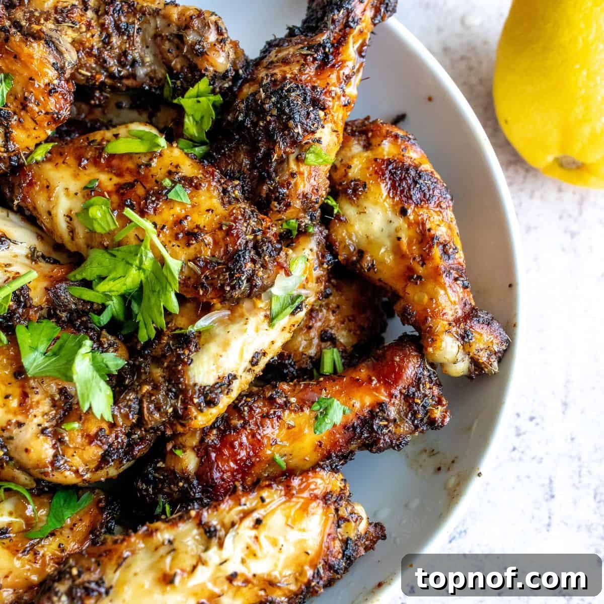 Zesty Air Fryer Lemon Pepper Wings served in a white bowl.