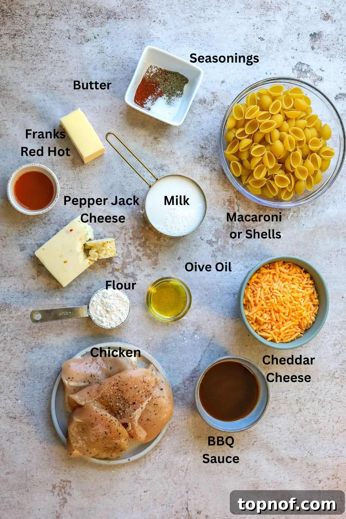 SMOKED BBQ CHICKEN MACARONI AND CHEESE 3 All the fresh ingredients meticulously arranged in small bowls on a kitchen counter, ready for preparation.