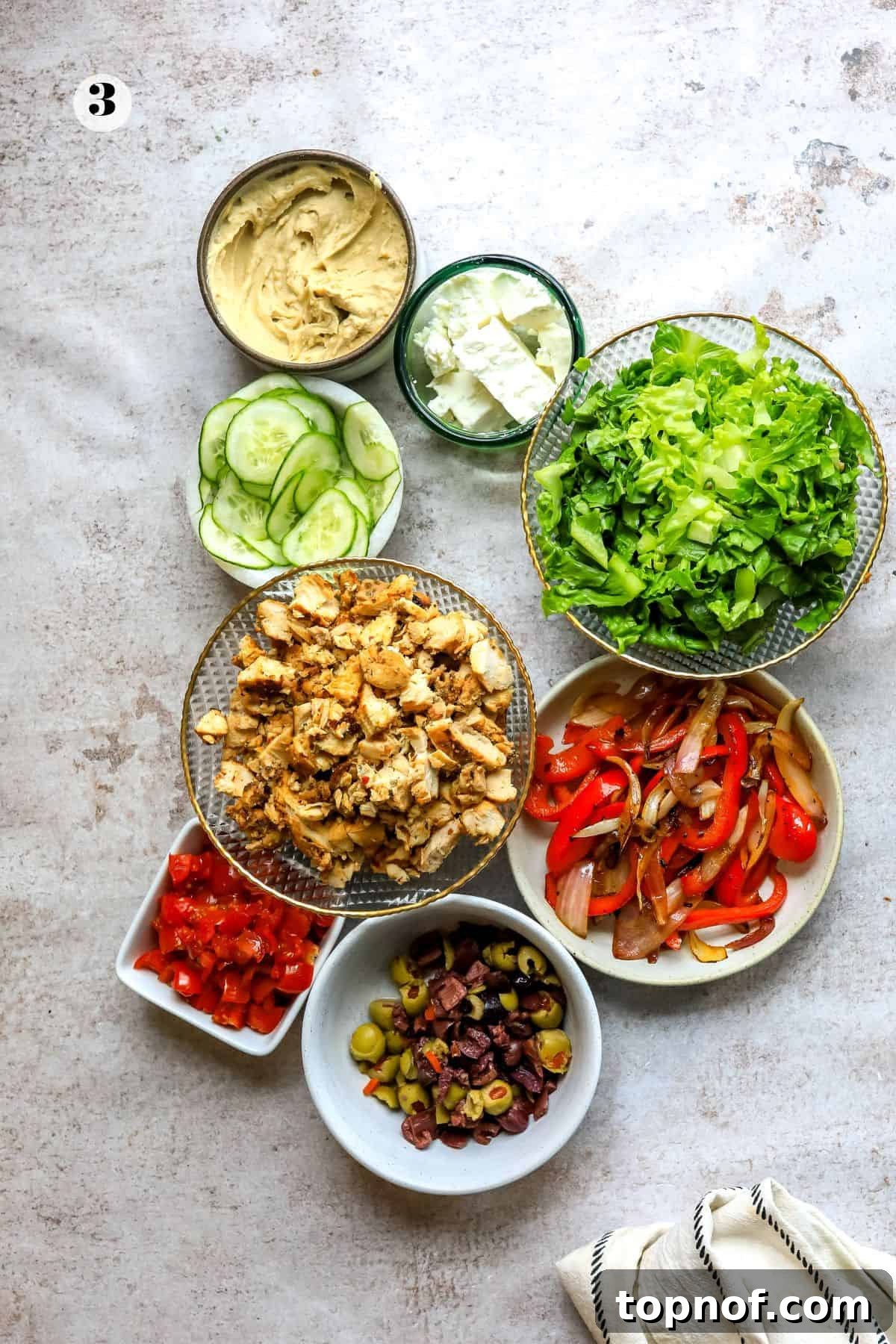 Vibrant Mediterranean Wraps 5 Various fresh ingredients, neatly chopped and placed in individual bowls, awaiting assembly into delicious wraps.