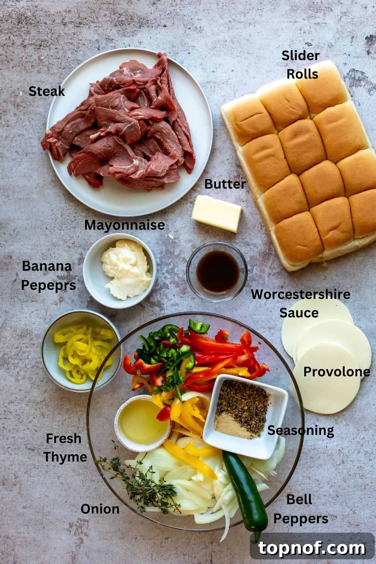 An image of the ingredients of philly cheesesteak sliders in separate containers.