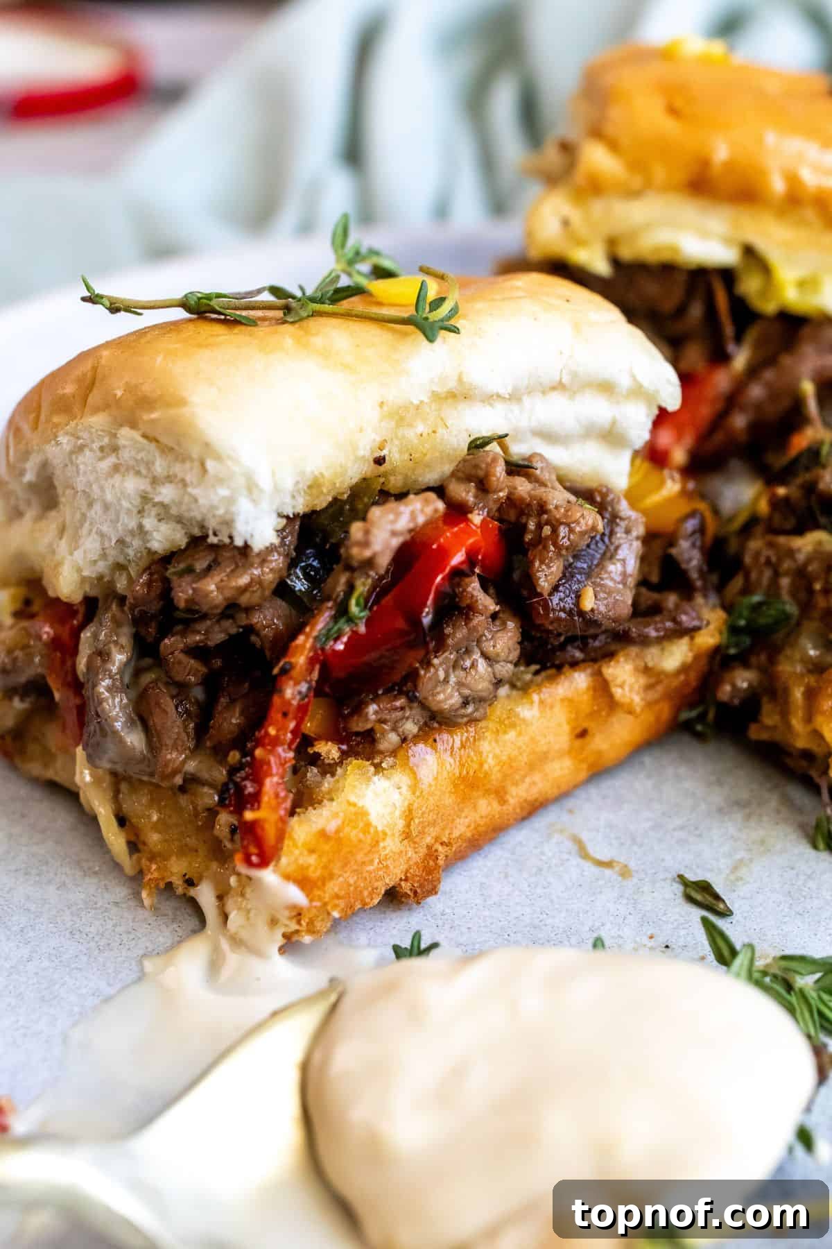 close up of sliders with thyme on top. 