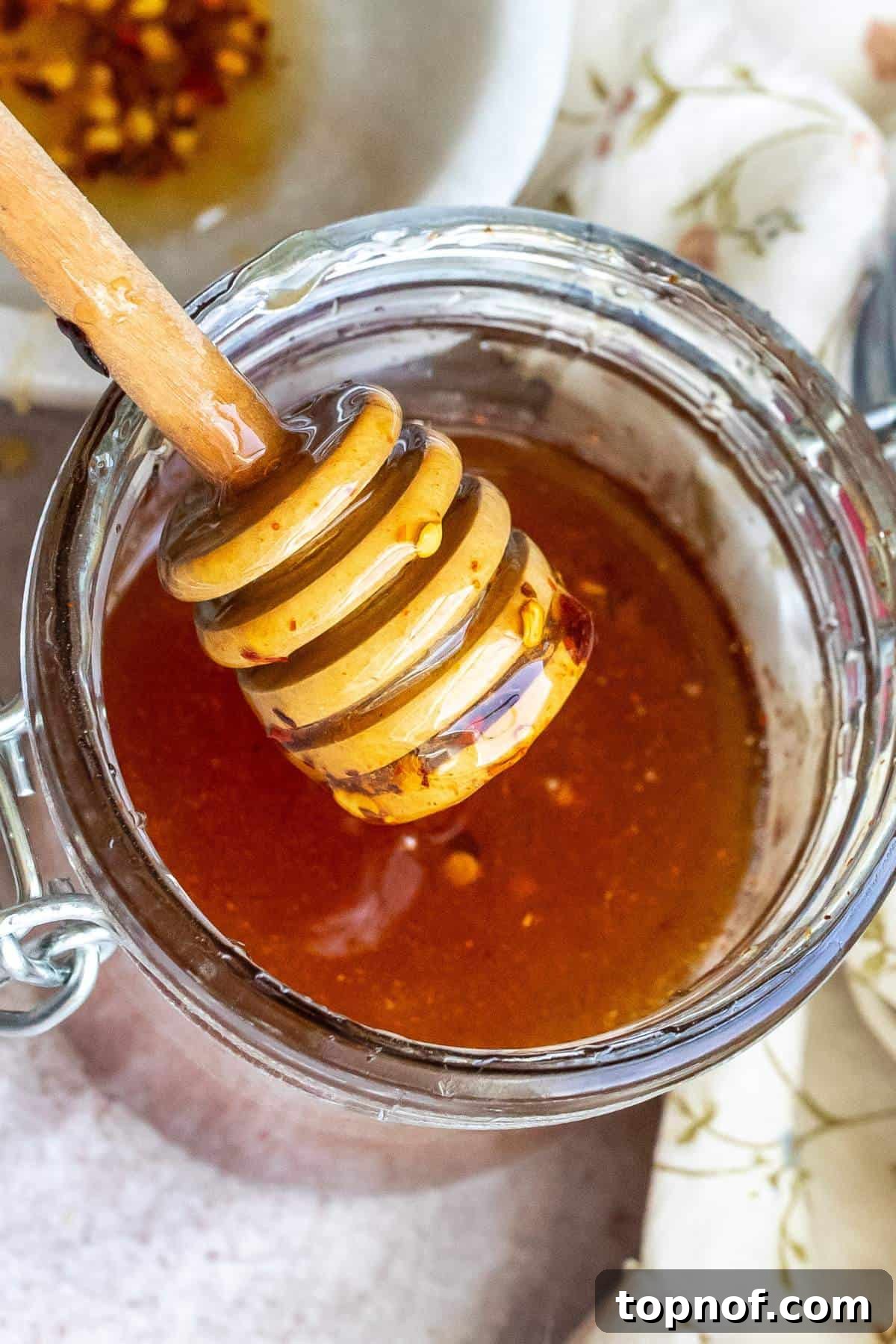 Up close photo of hot honey in a jar. 