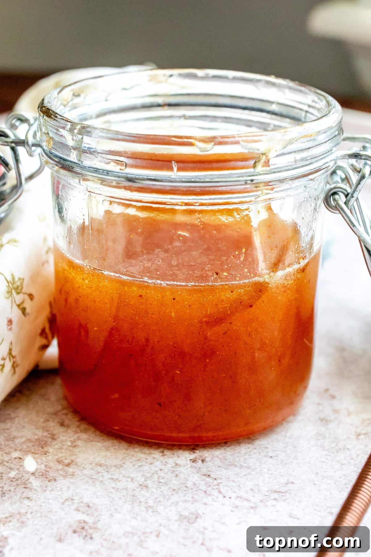 Up close photo of a jar with hot honey in it. 