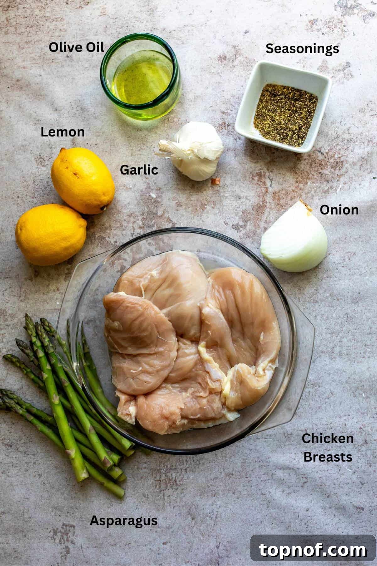 Peppery Citrus Chicken 3 Overhead shot of fresh ingredients including lemons, chicken, onions, garlic, and olive oil in preparation bowls.