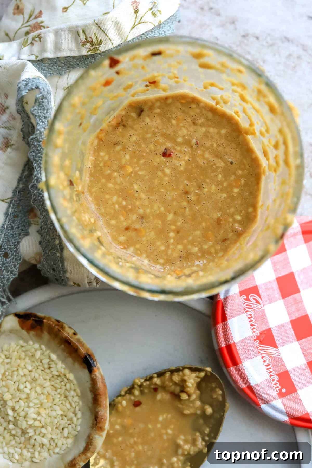 Savory Toasted Sesame Drizzle 2 A glass jar filled with luscious, creamy roasted sesame seed dressing, ready to be drizzled over your favorite meal.