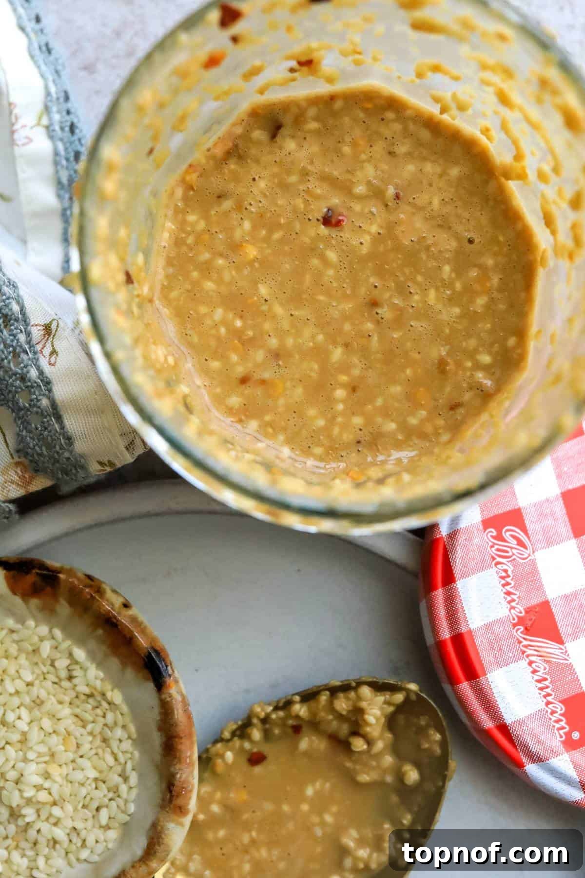 Savory Toasted Sesame Drizzle 5 A clear glass jar filled with the rich, creamy roasted sesame seed dressing, perfectly showcasing its inviting texture.