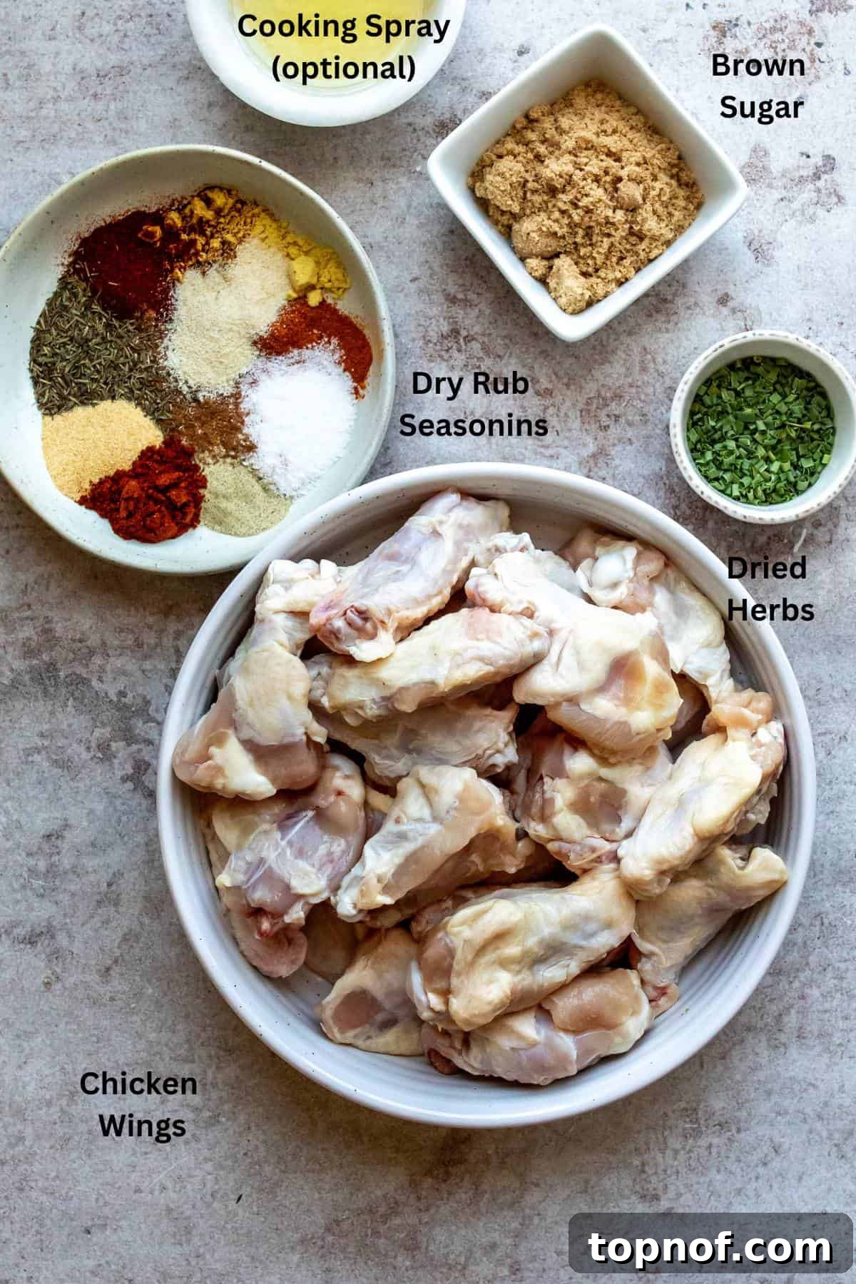 An overhead image of the ingredients of dry rub wings with labels, perfectly laid out for preparation.
