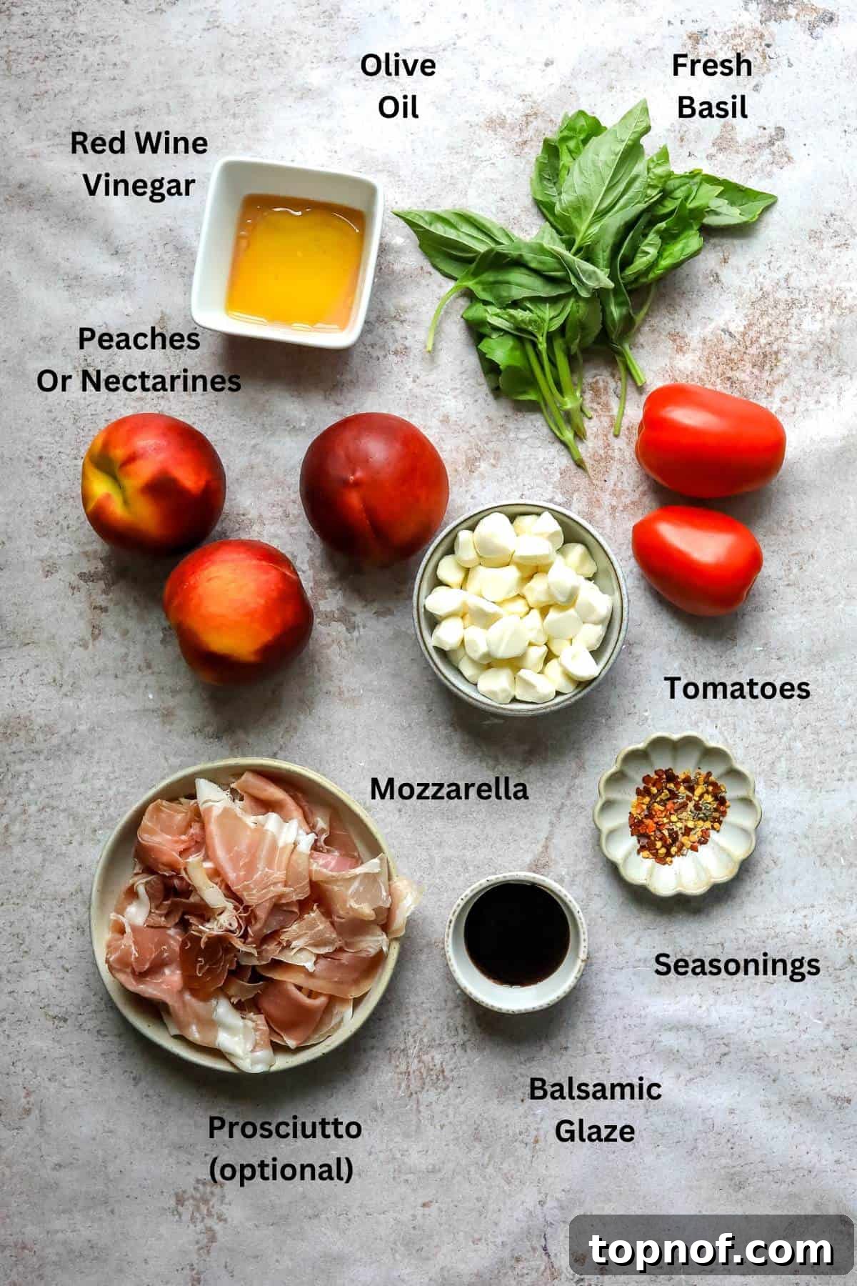 Overhead photo of small dishes with ingredients in them, showcasing fresh peaches, tomatoes, mozzarella, and basil.