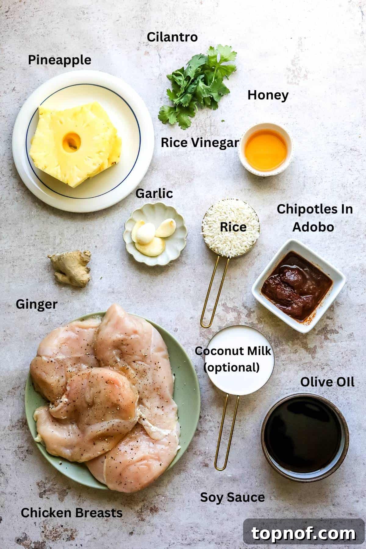 Sweet and Tangy Pineapple Chicken Adobo 3 Overhead photo of small bowls on a counter, showing ingredients like soy sauce, chipotles in adobo, pineapple, and ginger.
