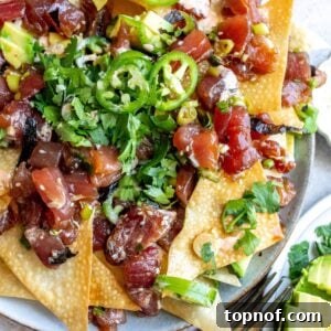 Poke Chip nachos on a plate with toppings.