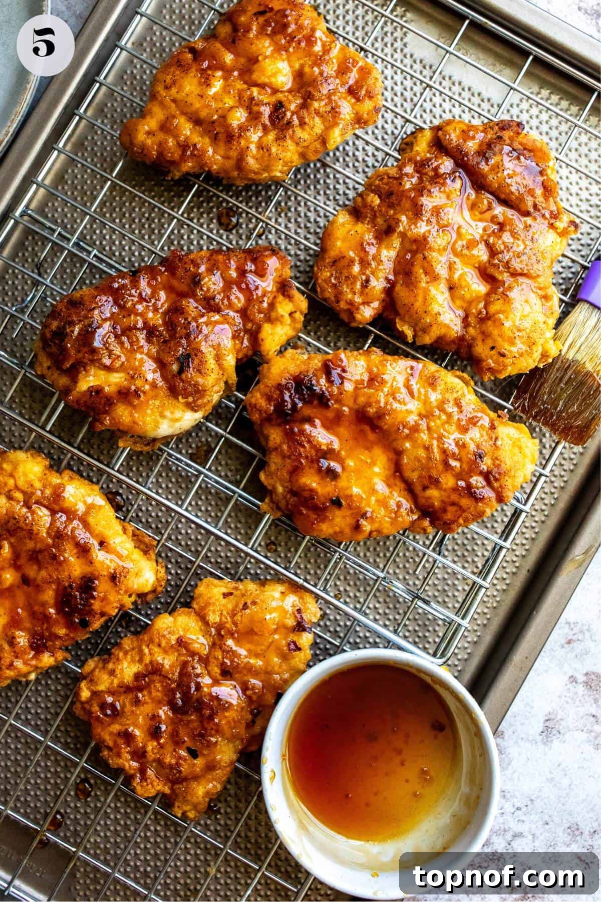 The Honey Blaze Chicken Sandwich 5 Crispy hot honey chicken breasts just out of the oven or skillet, glistening with golden perfection, ready for the hot honey glaze.