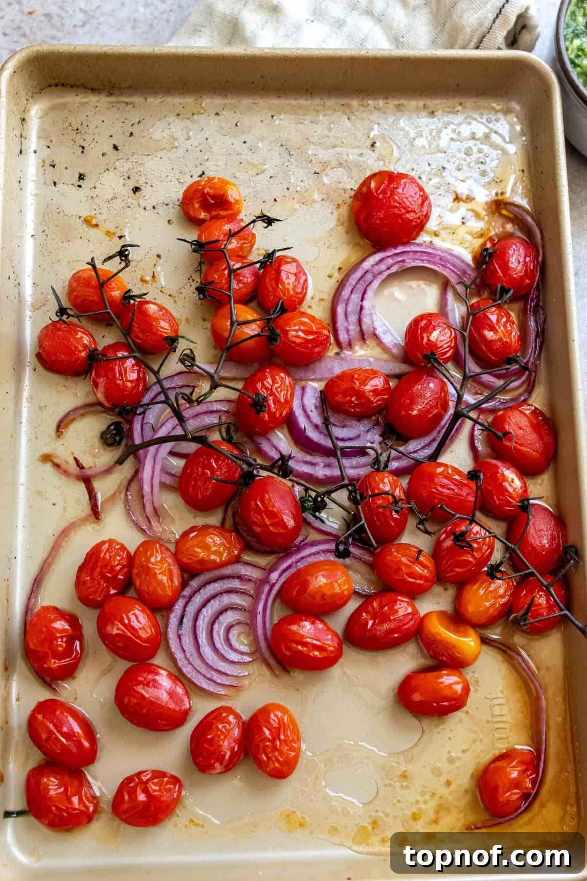 Burrata Pesto Perfection 4 Sheet pan with roasted cherry tomatoes and sliced red onions.