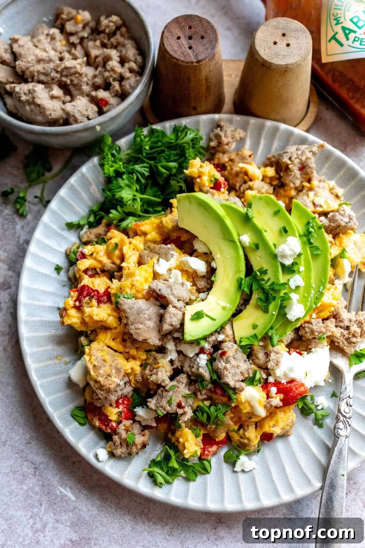 Premium Turkey Sausage 2 An image of turkey sausage on a plate with eggs, avocados, and veggies.