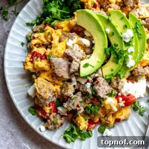 Premium Turkey Sausage 7 An image of turkey sausage on a plate with eggs, avocados, and veggies.