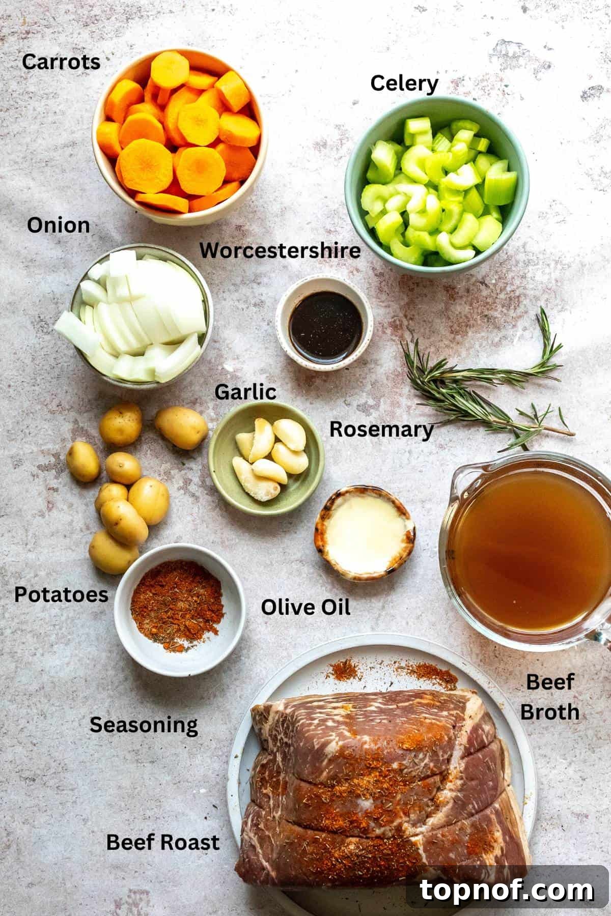 Fall-Apart Tender Chuck Roast 3 An image of fresh carrots, potatoes, onions, beef broth, garlic, and a cut of beef, ready for cooking.