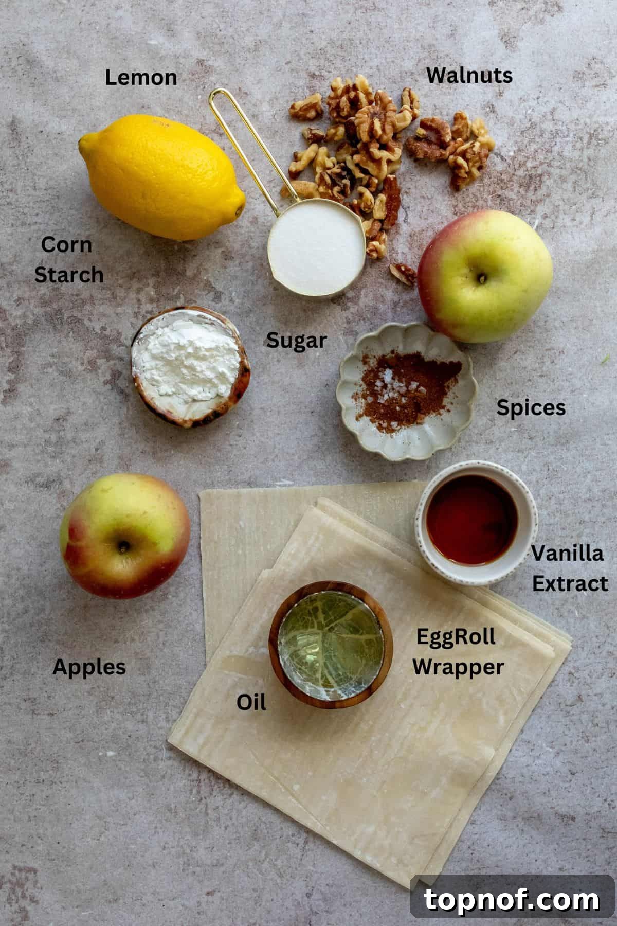 Crispy Apple Pie Rolls 3 Ingredients for apple pie egg rolls neatly arranged on a kitchen counter in various bowls and containers.