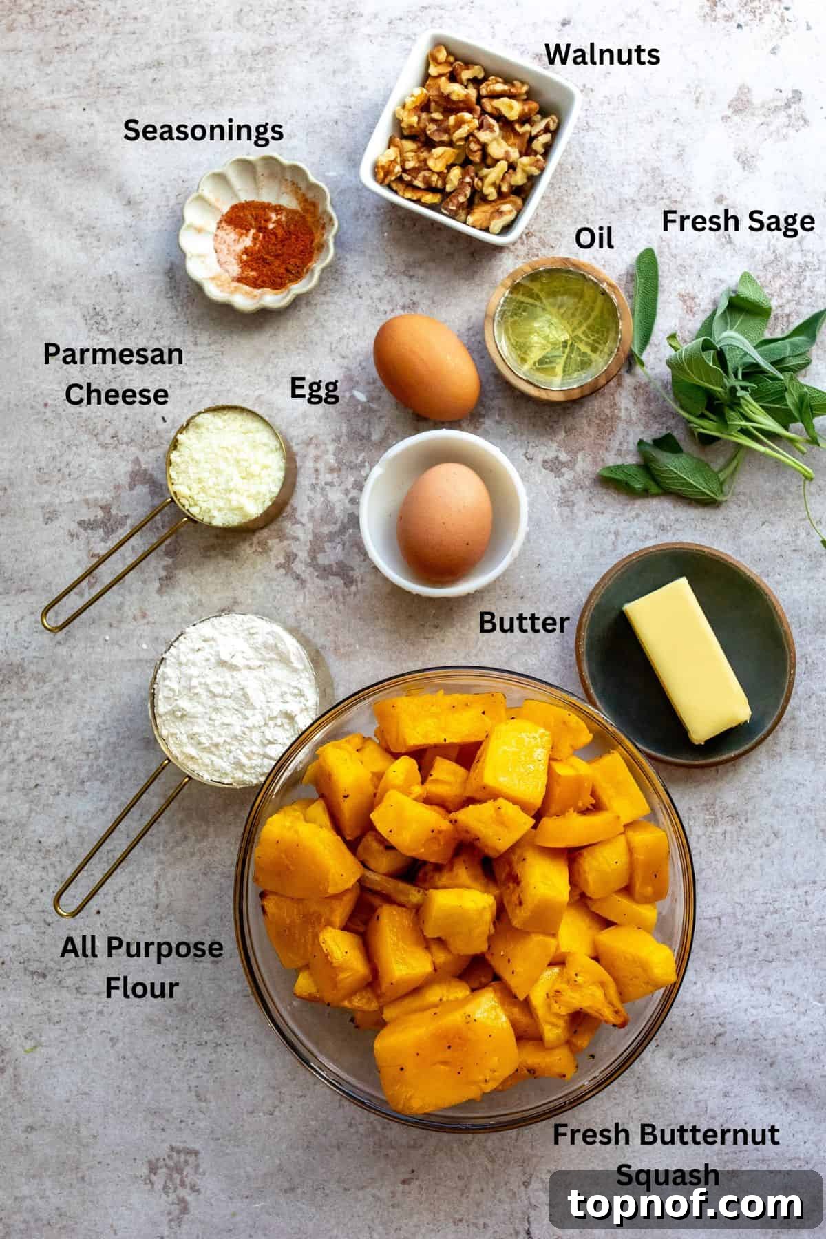 A flat lay image displaying all the fresh ingredients needed for the butternut squash gnocchi recipe on a rustic wooden surface.