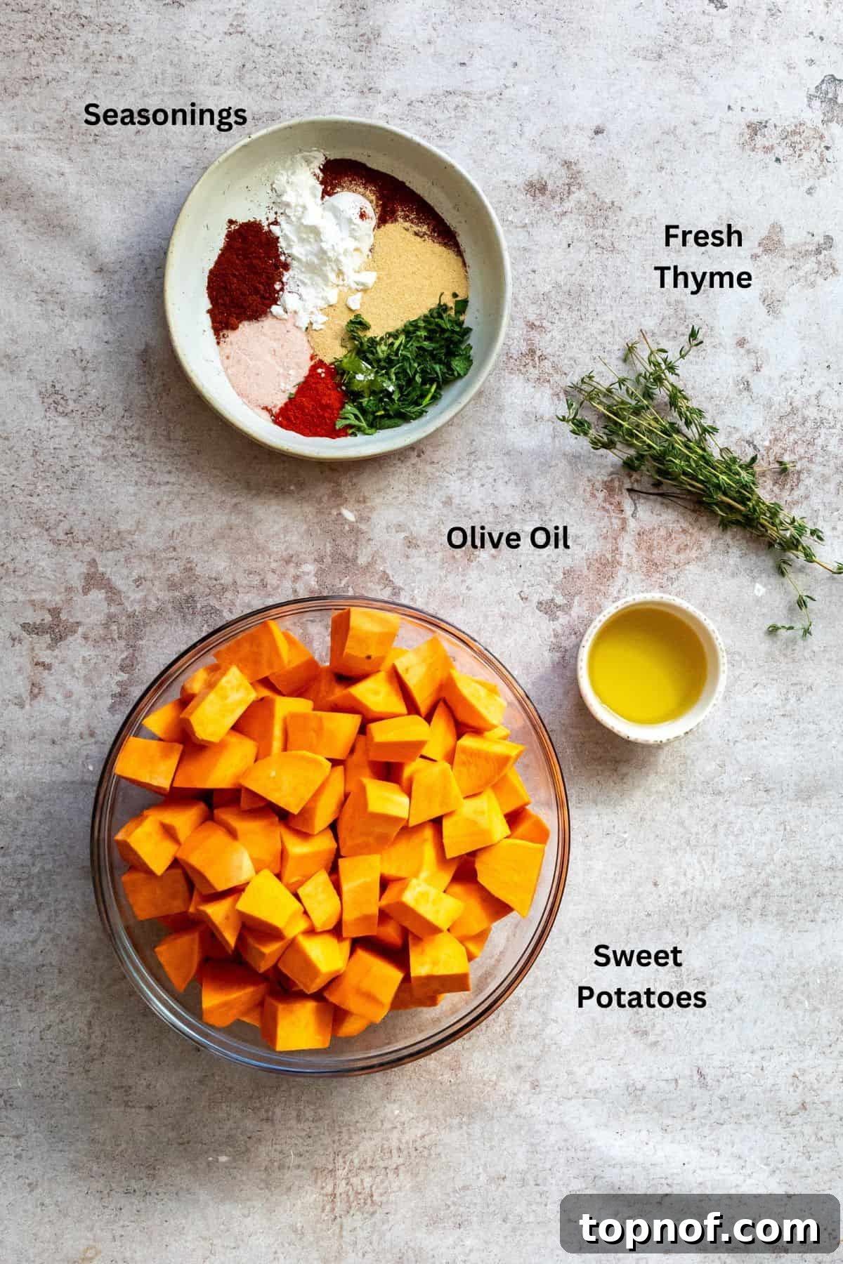 Crispy Baked Sweet Potatoes 3 An overhead shot showcasing all the fresh and dry ingredients meticulously laid out on a kitchen counter, ready for preparing crispy roasted sweet potatoes.