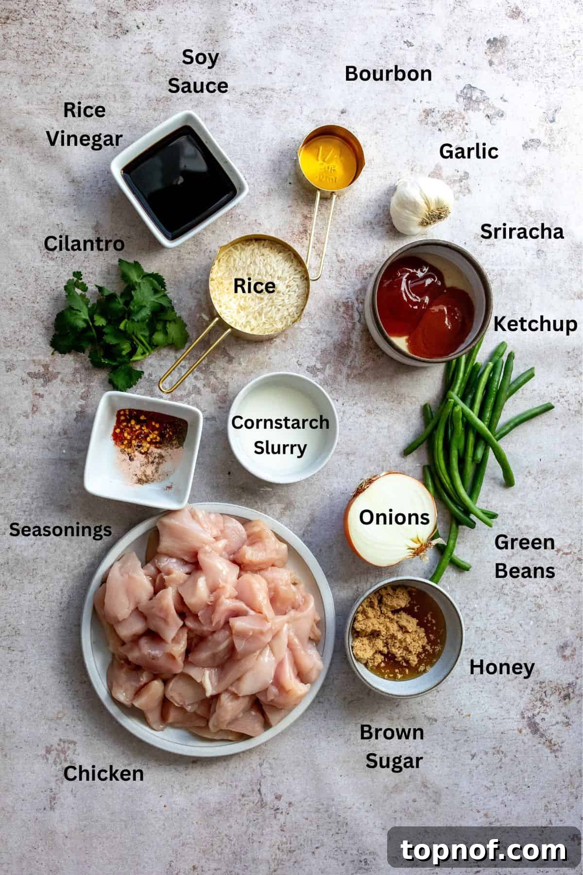 Golden Bourbon Honey Chicken 3 Ingredients needed to make the Honey Bourbon Chicken recipe, neatly arranged in small dishes on a kitchen counter.