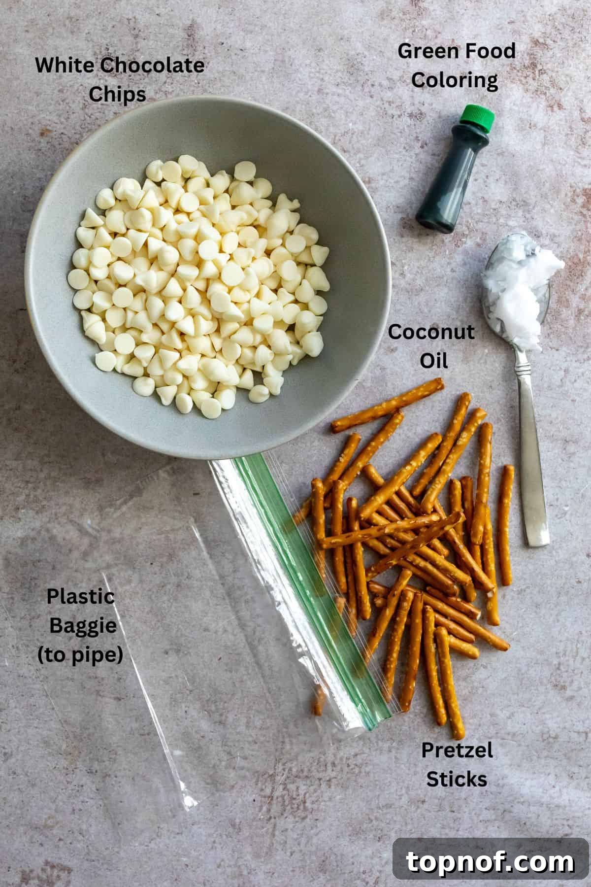 Festive Pretzel Tree Treats 3 Ingredients for pretzel Christmas trees laid out on a white surface.