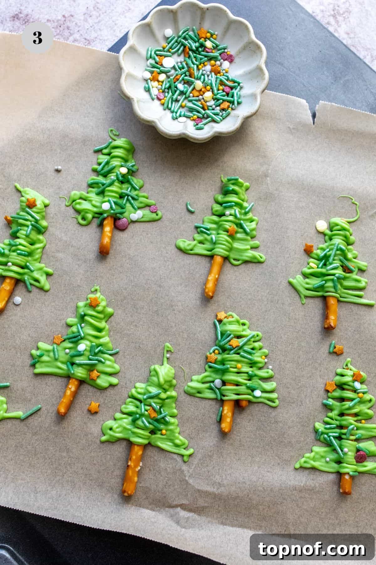 Festive Pretzel Tree Treats 5 Melted green chocolate being spooned into a ziplock bag.