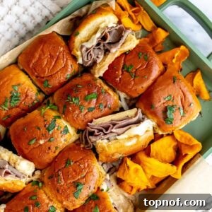 Premium Roast Beef Minis 7 Buttery Roast Beef Sliders in a green pan with sweet potato chips on the side, ready to be served.