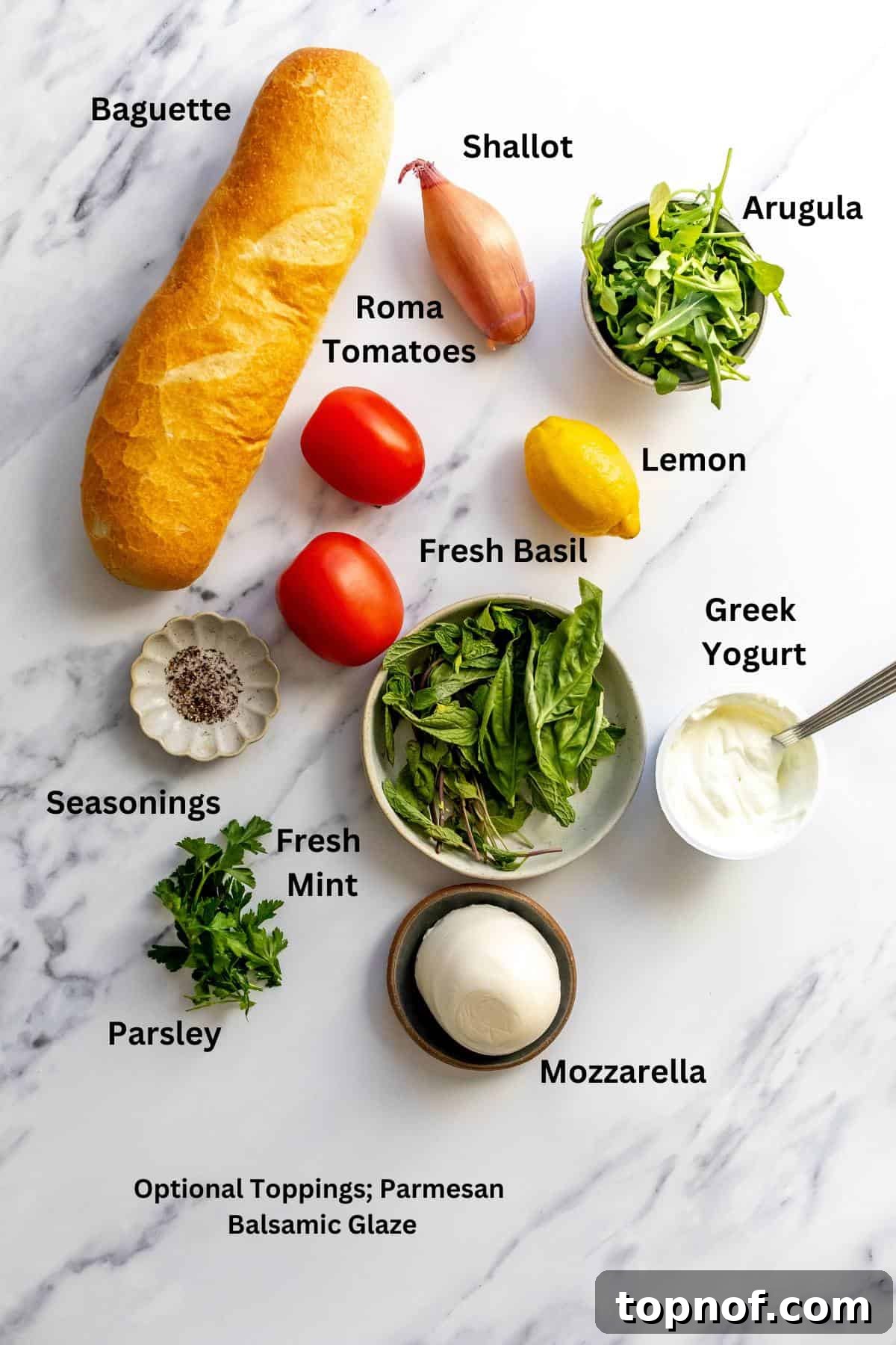 Various fresh ingredients like tomatoes, mozzarella, and herbs laid out on a kitchen counter, ready for assembly.