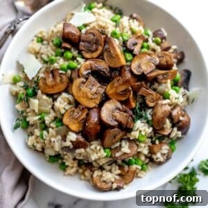 An overhead image of mushroom pea risotto in a bowl, ready to be enjoyed.