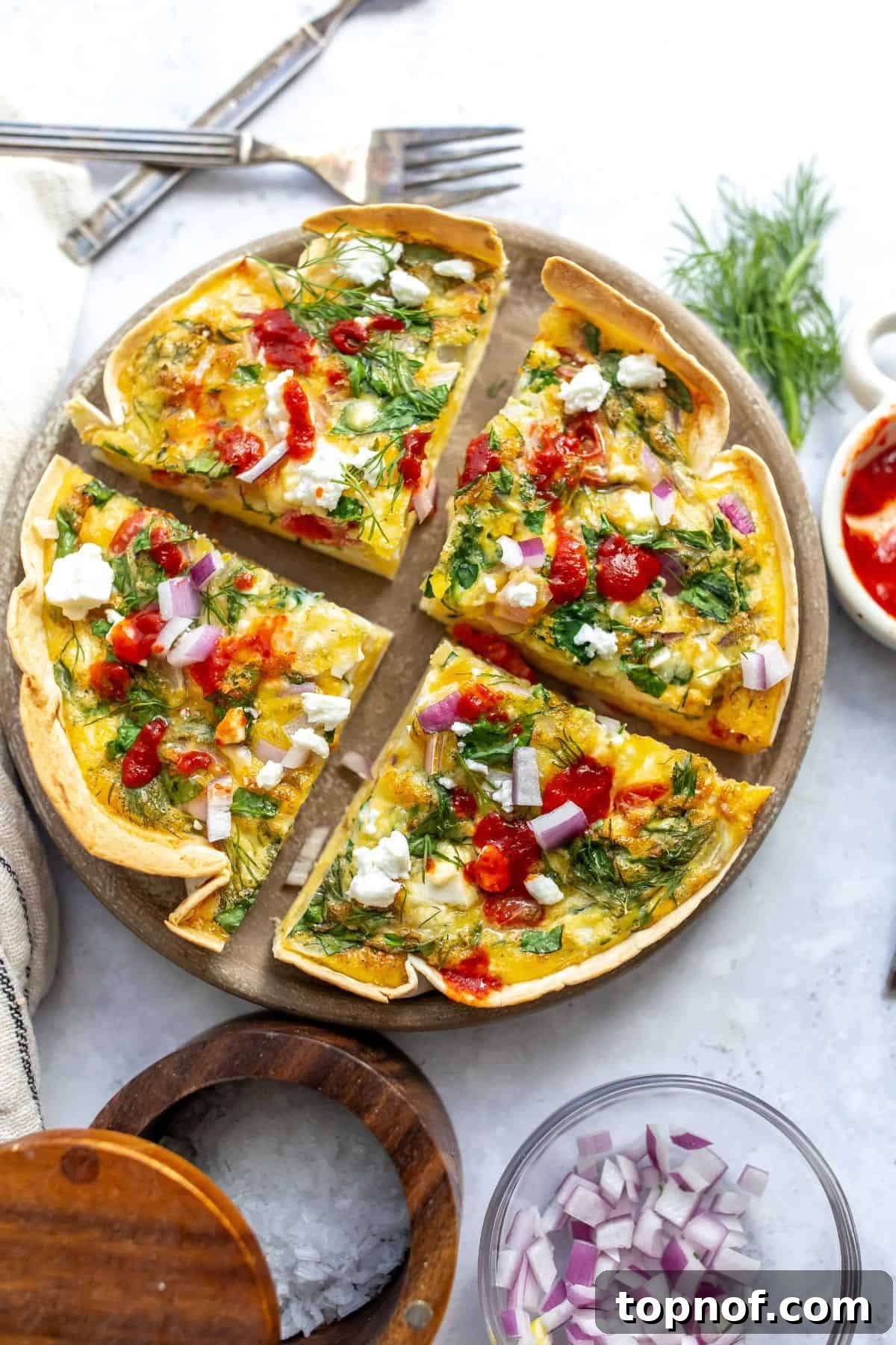 Savory Tortilla Quiche Casserole 2 An overhead image of a freshly baked tortilla quiche bake, sliced into four perfect portions on a rustic serving plate, garnished with fresh herbs.