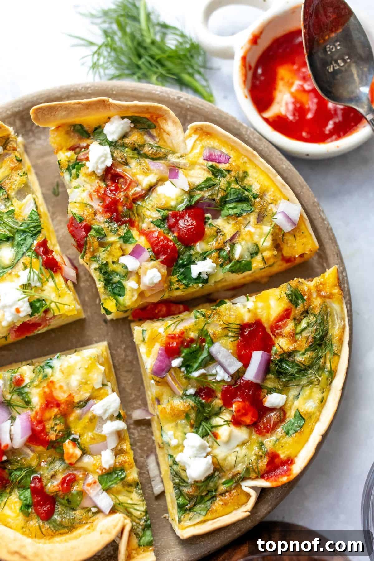 Savory Tortilla Quiche Casserole 5 A close-up image of the baked tortilla quiche, beautifully sliced into four pieces, highlighting the vibrant filling and crispy crust.