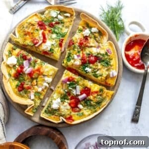 An overhead image of the tortilla quiche bake sliced in four on a serving plate.