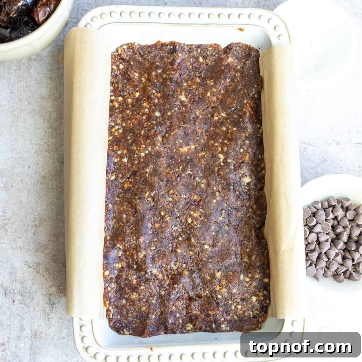 Golden Chewy No-Bake Blondie Squares 6 Layered no-bake blondies in a bread tin, with the date-walnut layer pressed onto the almond flour base.