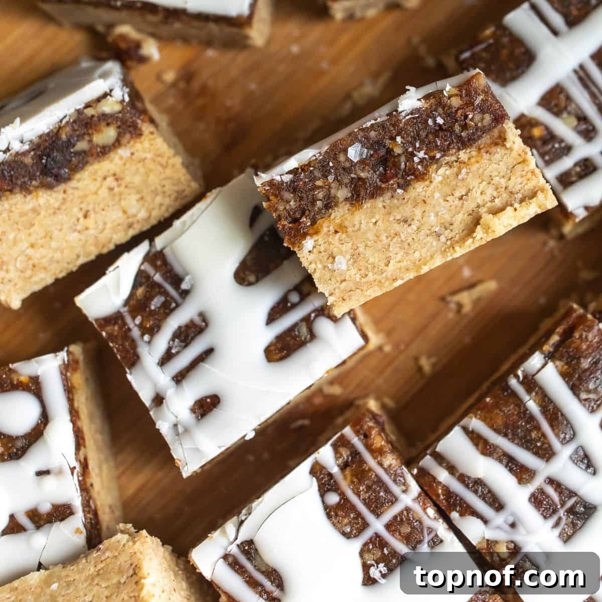 Golden Chewy No-Bake Blondie Squares 7 Close-up of freshly cut chewy no-bake blondies with a chocolate drizzle, showcasing their delicious layers.