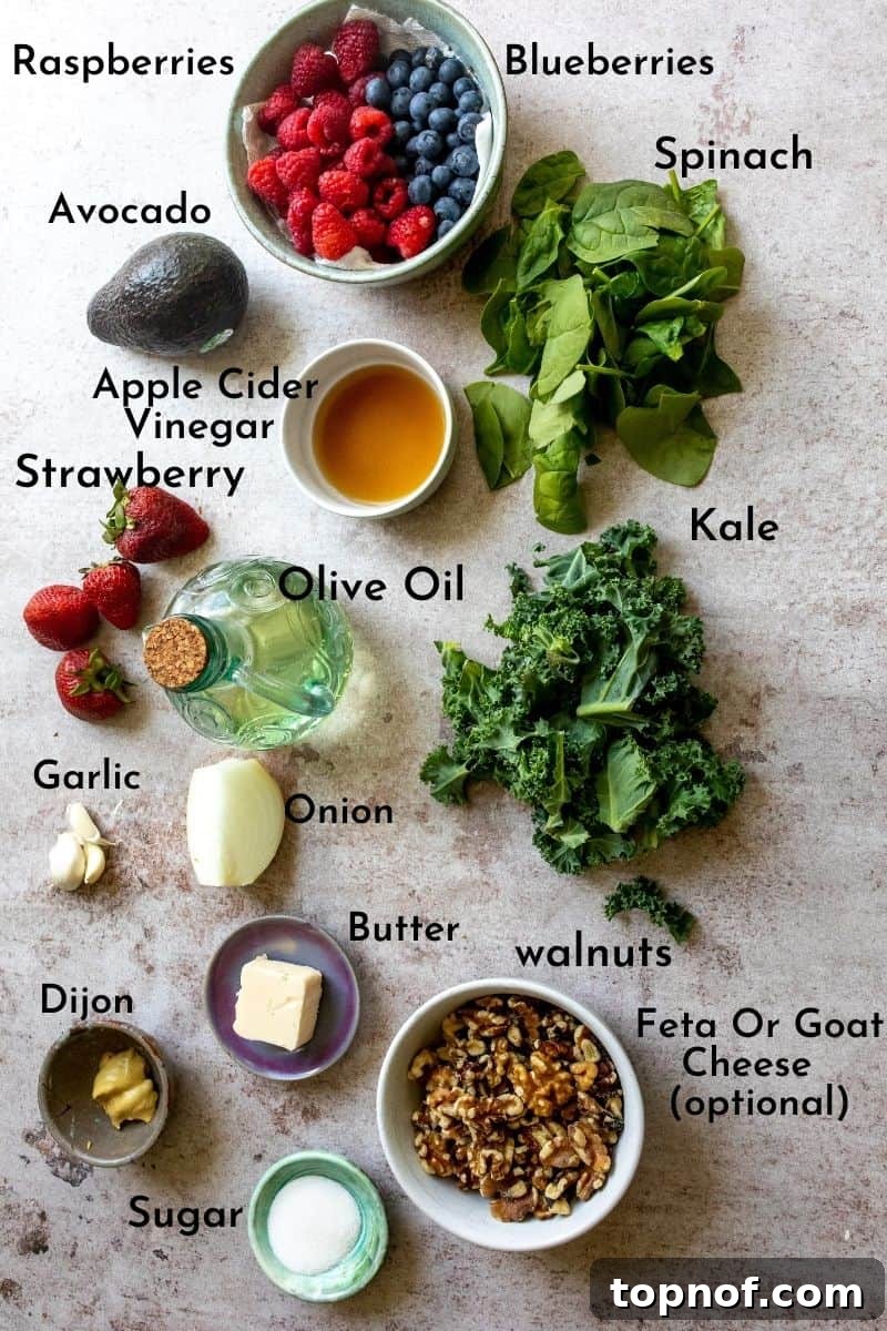Ingredients for salad with berries and raspberry Vinaigrette, laid out on a table.