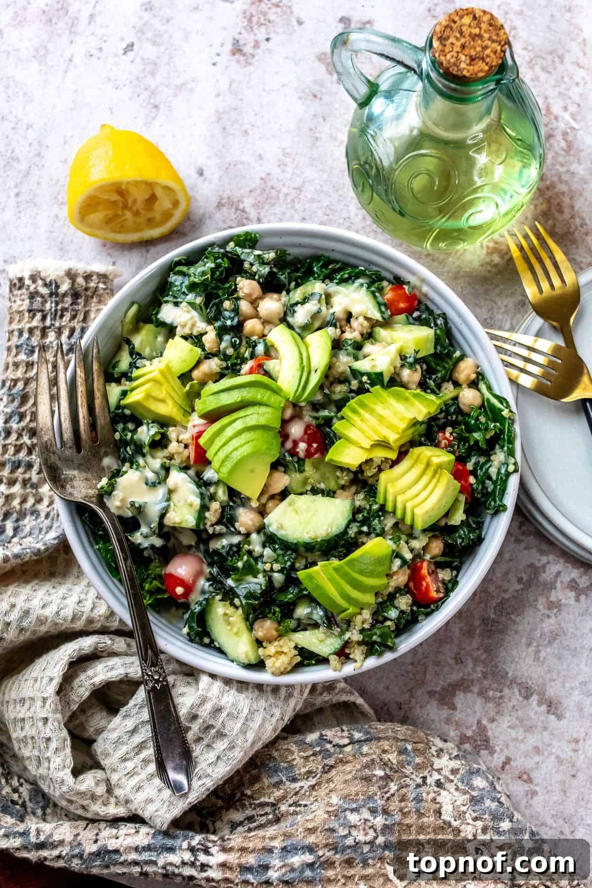 Vibrant Kale and Chickpea Salad 2 A beautifully arranged white bowl filled with a vibrant chickpea kale salad, generously topped with fresh vegetables and drizzled with a rich lemon honey dressing. Perfect for a healthy meal.