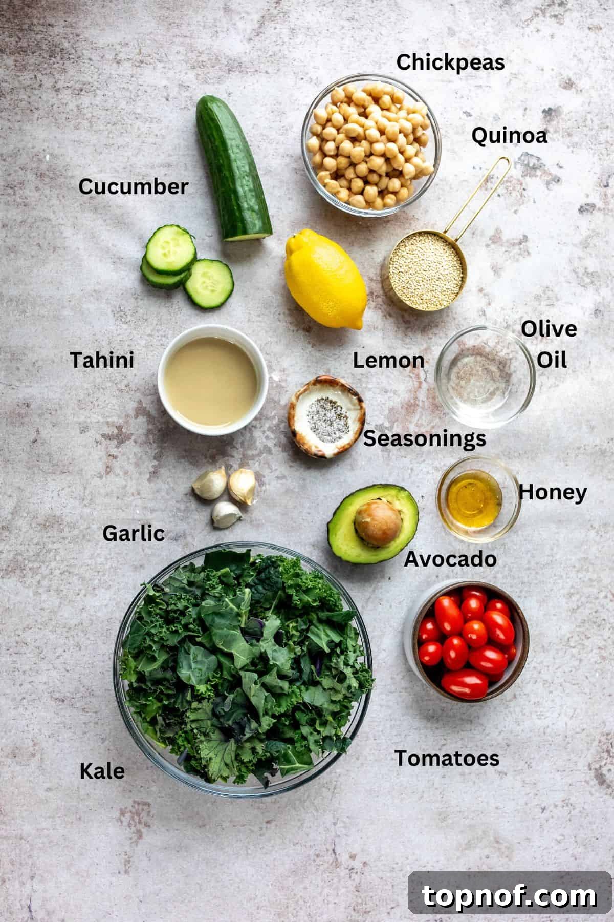 Vibrant Kale and Chickpea Salad 3 A vibrant array of fresh ingredients, including brilliant green kale, golden cooked quinoa, plump chickpeas, and bright lemons, thoughtfully arranged in glass bowls on a clean kitchen counter, ready for salad preparation.