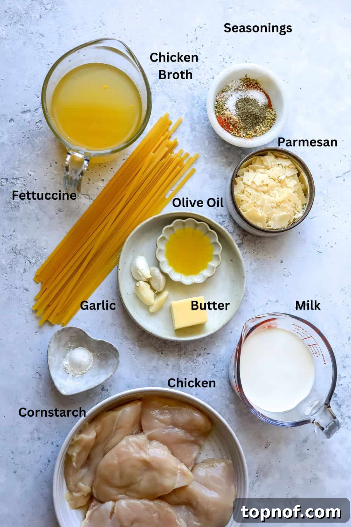 Cajun Spiced Chicken Fettuccine Alfredo 3 Ingredients needed to make this recipe on a counter in bowls and small dishes.