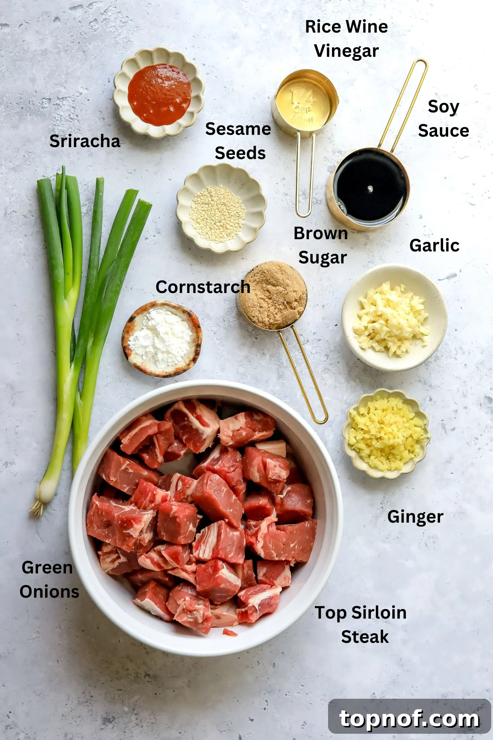 Aromatic Garlic Ginger Beef Skewers 3 Ingredients needed to make this recipe, neatly arranged on a counter in small white bowls, ready for preparation.