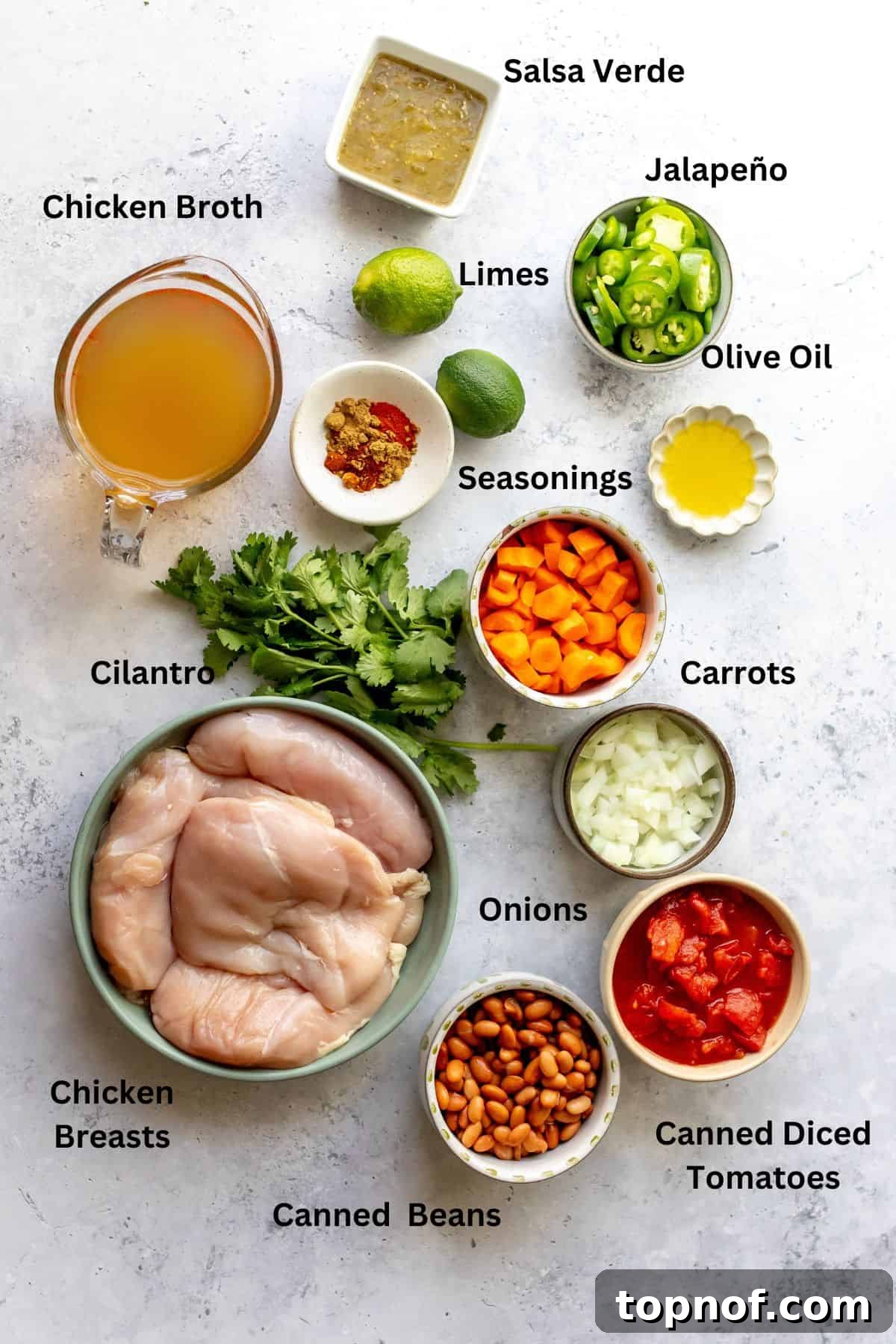 Zesty Chicken Lime Fiesta Soup 3 Assortment of fresh ingredients laid out on a white countertop, ready for preparing Mexican Chicken Lime Soup.