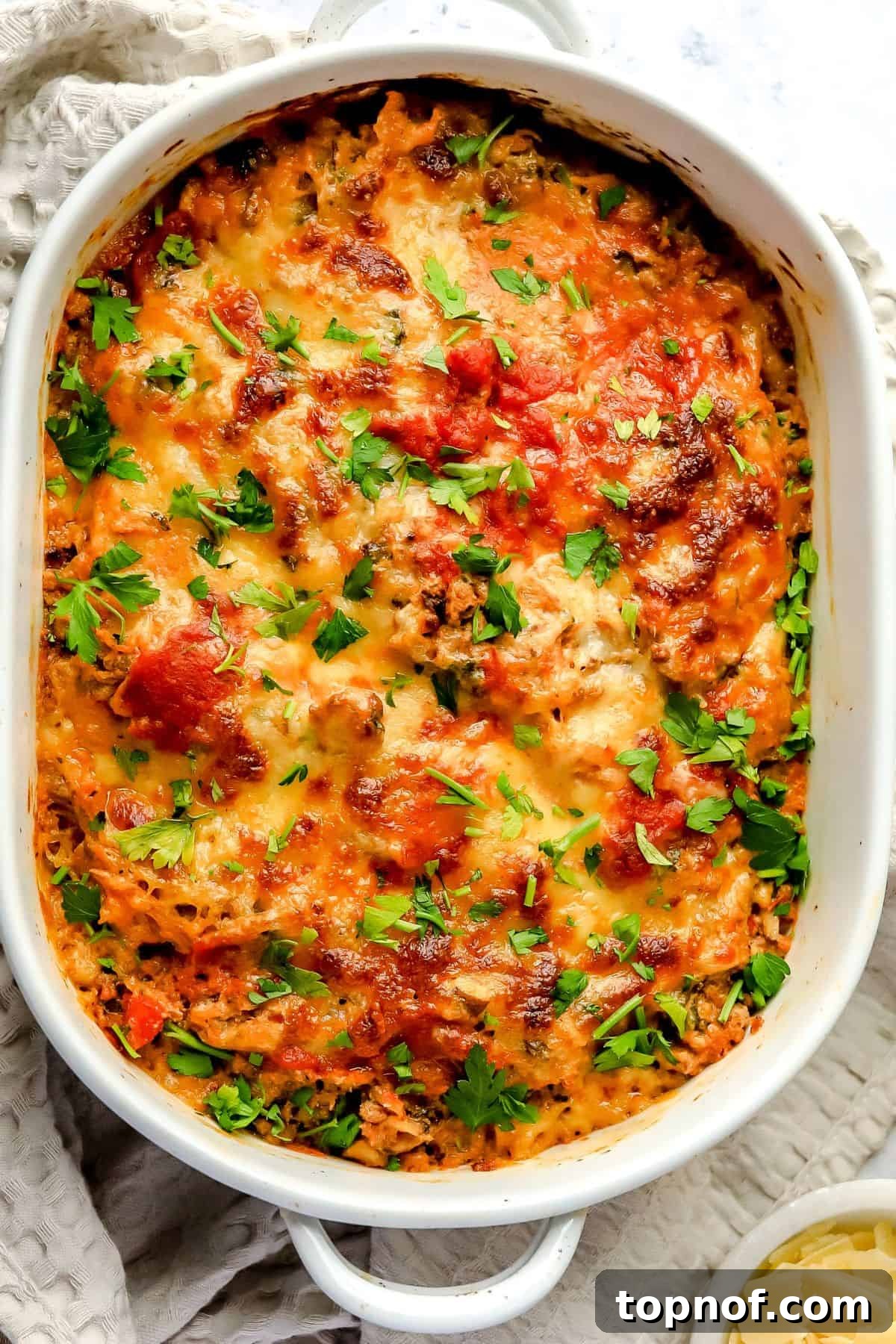 Wholesome Spaghetti Squash Lasagna 6 A full white casserole dish of freshly baked Spaghetti Squash Lasagna, showing its cheesy, bubbling surface and rich texture.